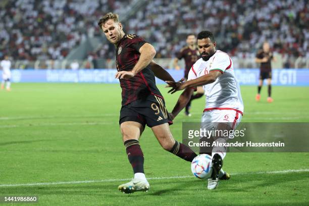 Niklas Füllkrug of Germany battles for the ball with Ahmed Al-Khamish of Oman during the international friendly match between Germany and Oman at...