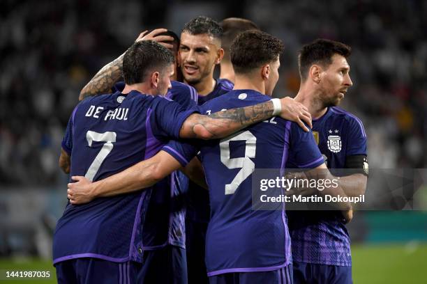 Lionel Messi of Argentina celebrates with teammate Julian Alvarez and Rodrigo de Paul during the international friendly between United Arab Emirates...
