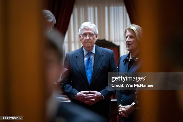 Senate Minority Leader Mitch McConnell talks with members of his leadership team at the end of a meeting with Senate Republicans in the Old Senate...