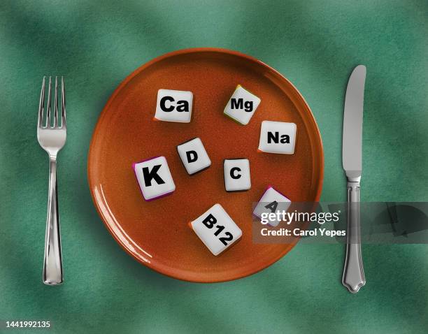 fork and cons of minerals and macronutrients. selection of foods with a high content of vitamins and trace elements.choosing magnesium - calcita mineral fotografías e imágenes de stock