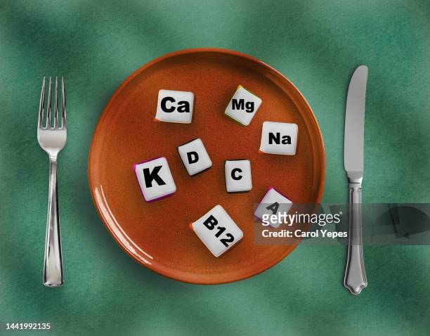fork and cons of minerals and macronutrients. selection of foods with a high content of vitamins and trace elements.choosing magnesium - vitamins and minerals imagens e fotografias de stock