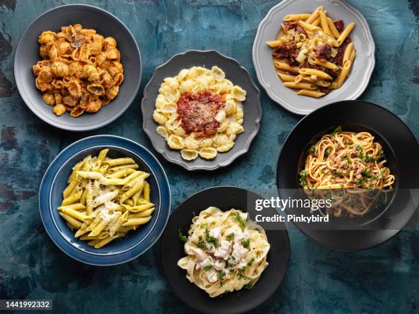 varios tipos de pasta cocida y fideos sobre el fondo, pasta, fideos, macarrones, variación de pasta, colección de diferentes pastas en la mesa de cocción - pasta fotografías e imágenes de stock