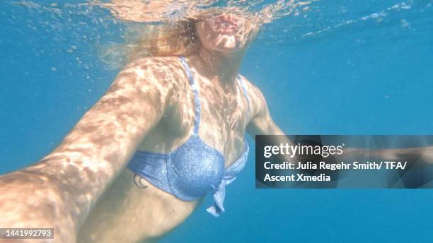 underwater view of young woman swimming in sea - pov or personal perspective or immersion stock pictures, royalty-free photos & images