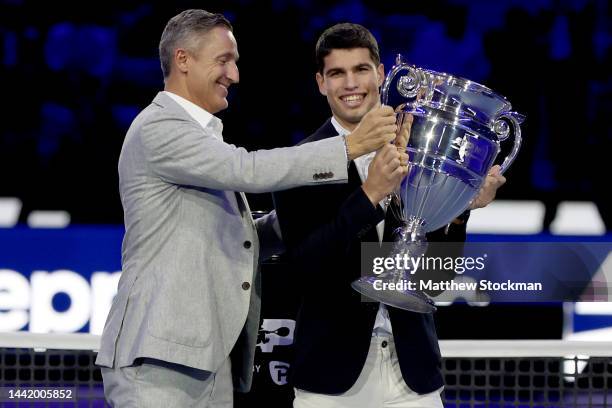 Chairman Andrea Gaudenzi presents Carlos Alcaraz of Spain with the ATP Year End Number One Trophy during day four of the Nitto ATP Finals at Pala...