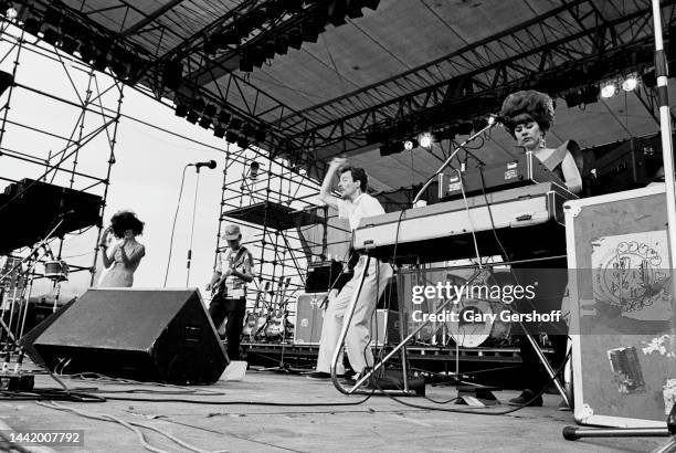 View of, from left, American New Wave musicians Cindy Wilson, Ricky Wilson , on guitar, Fred Schneider, and Kate Pierson, on keyboards, all of the...