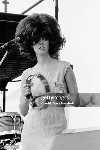 American New Wave musician Cindy Wilson, of the group the B-52's, plays tambourine as she performs onstage during the Heatwave Festival at Mosport...