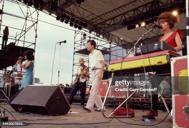 View of, from left, American New Wave musicians Cindy Wilson , Ricky Wilson , on guitar, Fred Schneider, and Kate Pierson, on keyboards, all of the...