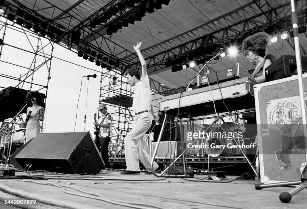 View of, from left, American New Wave musicians Cindy Wilson, Ricky Wilson , on guitar, Fred Schneider, and Kate Pierson, on keyboards, all of the...