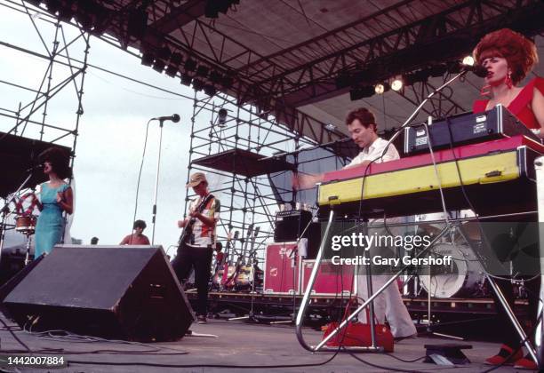 View of, from left, American New Wave musicians Cindy Wilson , Ricky Wilson , on guitar, Fred Schneider, and Kate Pierson, on keyboards, all of the...