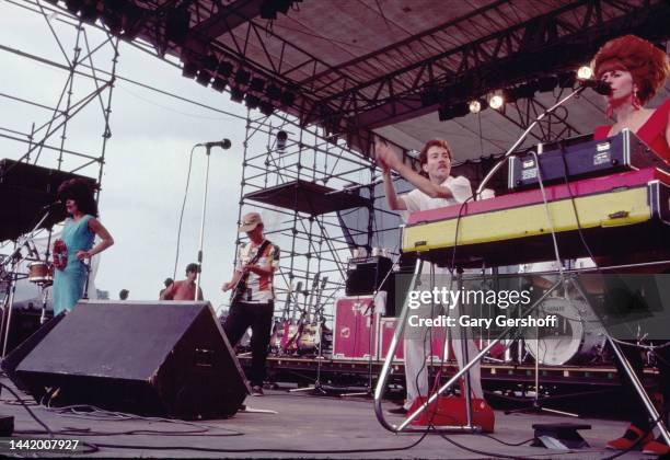 View of, from left, American New Wave musicians Cindy Wilson , Ricky Wilson , on guitar, Fred Schneider, and Kate Pierson, on keyboards, all of the...