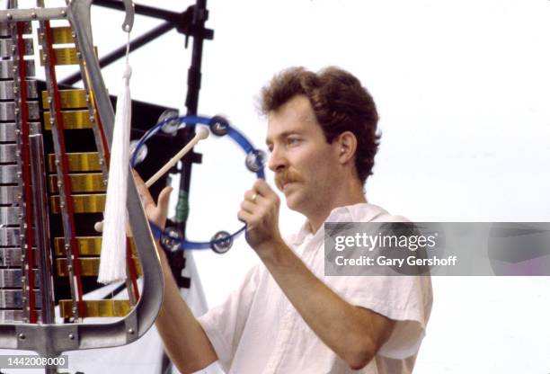 American New Wave musician Fred Schneider, of the group the B-52's, plays tambourine as he performs onstage during the Heatwave Festival at Mosport...