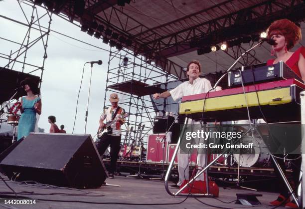 View of, from left, American New Wave musicians Cindy Wilson , Ricky Wilson , on guitar, Fred Schneider, and Kate Pierson, on keyboards, all of the...