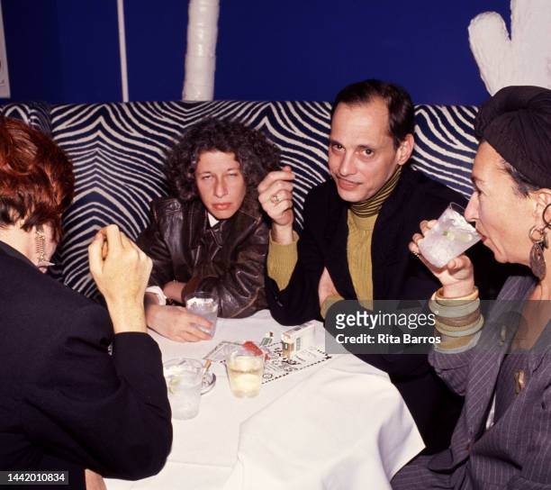 View of, from rear left, American author Fran Leibowitz, film director John Waters, and photographer Henny Garfunkel as they sit together in the El...