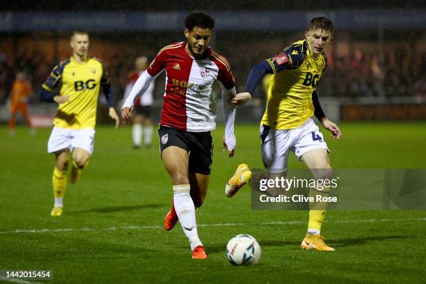 Kyran Lofthouse of Woking FC is challenged by Steve Seddon of Oxford United during the Emirates FA Cup First Round match between Woking FC and Oxford...