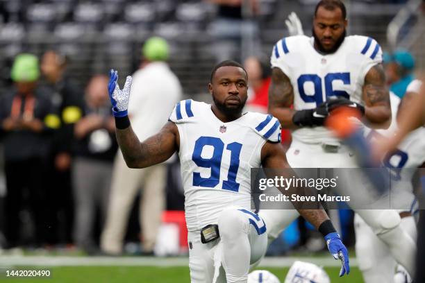 Defensive end Yannick Ngakoue of the Indianapolis Colts stretches before a game against the Las Vegas Raiders at Allegiant Stadium on November 13,...