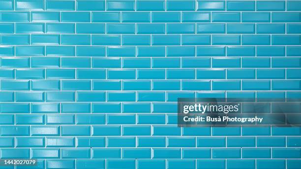 bright blue brick tiled wall - piastrelle foto e immagini stock