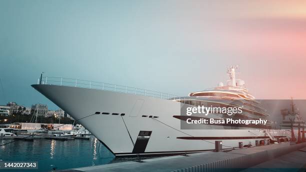 luxury yacht moored in the marina of barcelona - luxe jacht stockfoto's en -beelden