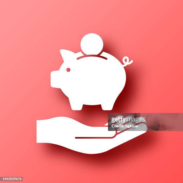 sparschwein in der hand. symbol auf rotem hintergrund mit schatten - piggy bank stock-grafiken, -clipart, -cartoons und -symbole