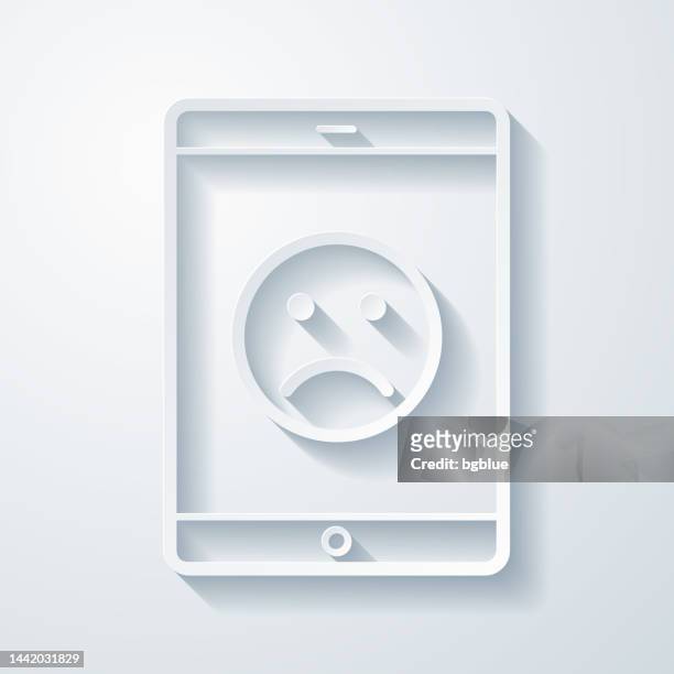 stockillustraties, clipart, cartoons en iconen met tablet pc with sad emoji. icon with paper cut effect on blank background - disappointing phone