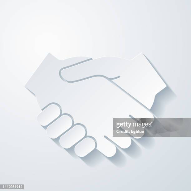 handshake. icon with paper cut effect on blank background - hand shake gesture white background isolated stock illustrations