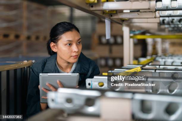 female worker working at factory warehouse checking the product before packaging and transportation. - inventory management stock pictures, royalty-free photos & images