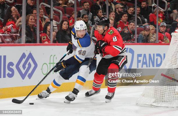 Jack Johnson of the Chicago Blackhawks defends Ivan Barbashev of the St. Louis Blues during the first period at United Center on November 16, 2022 in...