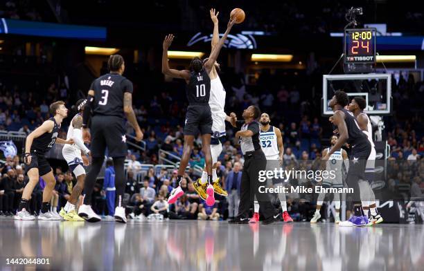 Bol Bol of the Orlando Magic and Karl-Anthony Towns of the Minnesota Timberwolves jump ball during a game at Amway Center on November 16, 2022 in...