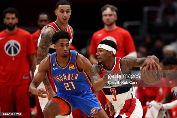Bradley Beal of the Washington Wizards drives around Aaron Wiggins of the Oklahoma City Thunder in the first half at Capital One Arena on November...