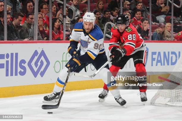 Ryan O'Reilly of the St. Louis Blues is defended by Patrick Kane of the Chicago Blackhawks during the first period at United Center on November 16,...