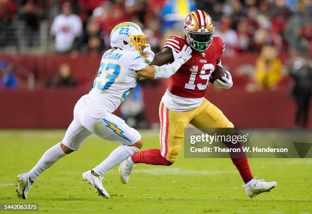 Deebo Samuel of the San Francisco 49ers running with the ball fights off the tackle of Bryce Callahan of the Los Angeles Charger during the fourth...