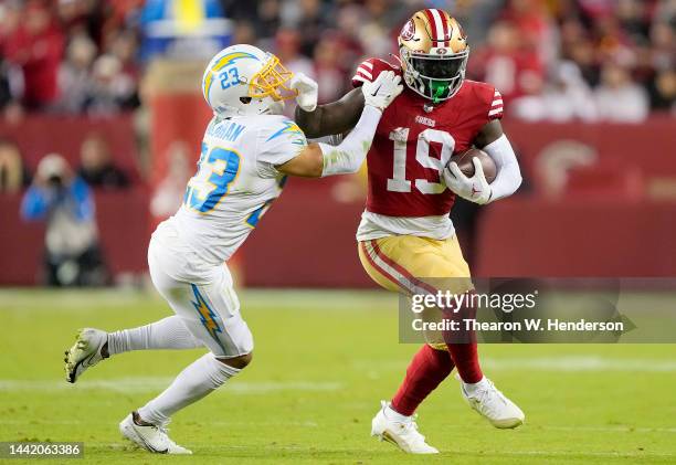 Deebo Samuel of the San Francisco 49ers running with the ball fights off the tackle of Bryce Callahan of the Los Angeles Charger during the fourth...