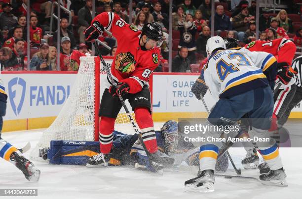 Jordan Binnington the St. Louis Blues makes a save on Caleb Jones the Chicago Blackhawks at United Center on November 16, 2022 in Chicago, Illinois.