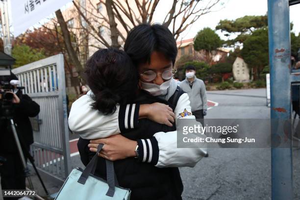 Mother hugs on her son taking the College Scholastic Ability Test on November 17, 2022 in Seoul, South Korea. The annual College Scholastic Ability...