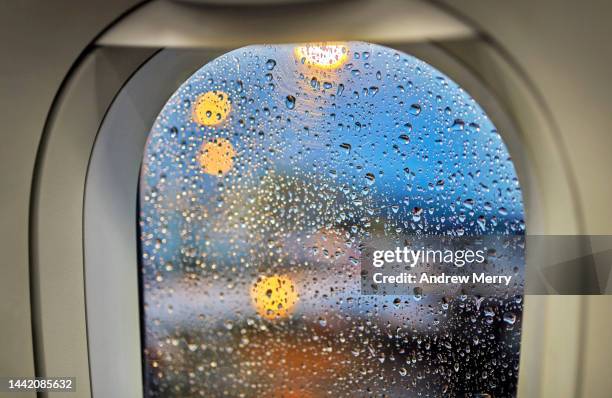 rainy weather out airplane window waiting at airport - postpone stock pictures, royalty-free photos & images