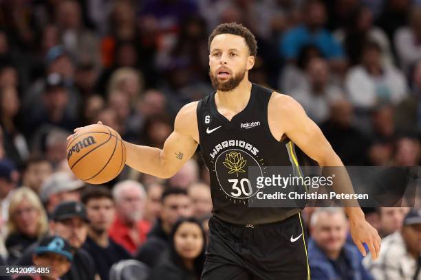 Stephen Curry of the Golden State Warriors handles the ball during the first half of the NBA game at Footprint Center on November 16, 2022 in...