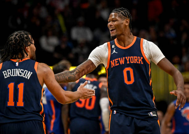 Cam Reddish celebrates with Jalen Brunson of the New York Knicks after Brunson dunked on a breakaway against the Denver Nuggets during the fourth...