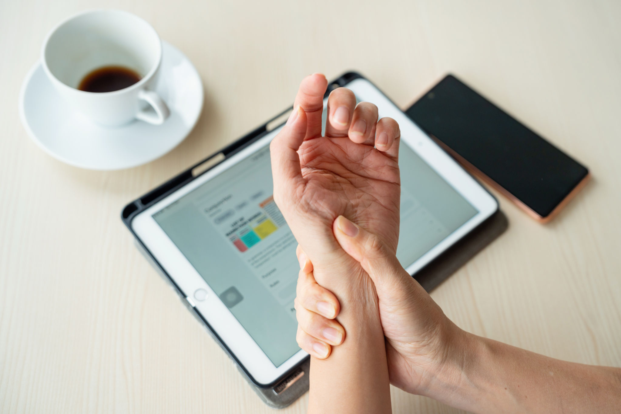 Close-up woman massaging her arthritic hand and wrist, she is suffering from pain and rheumatism. Close-up woman massaging her arthritic hand and wrist, she is suffering from pain and rheumatism.