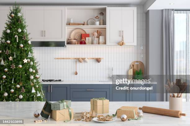 homemade christmas cookies and gift boxes on kitchen counter. modern kitchen with christmas decorations. baking and selling cookies - yule marble stock pictures, royalty-free photos & images