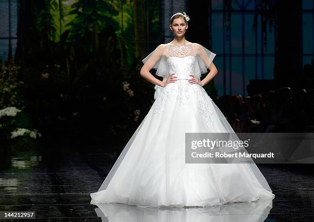 Model walks the runway for the latest Pronovias Fashion collection at the Museu Nacional d’Art de Catalunya on May 11, 2012 in Barcelona, Spain.