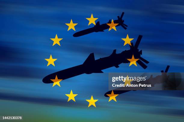 cruise missiles on the background of the flag of eu - cruise missile stock-fotos und bilder