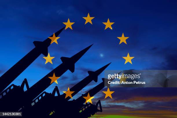 missile system on the background of the flag of eu - arms stockfoto's en -beelden