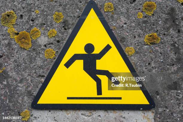 sign beware slippery floor on concrete wall - drop stop stock pictures, royalty-free photos & images
