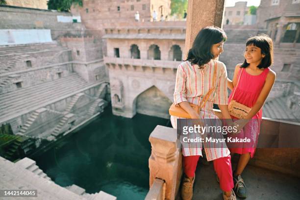 Mother and daughter tourist sitting at a step well  Jodhpur