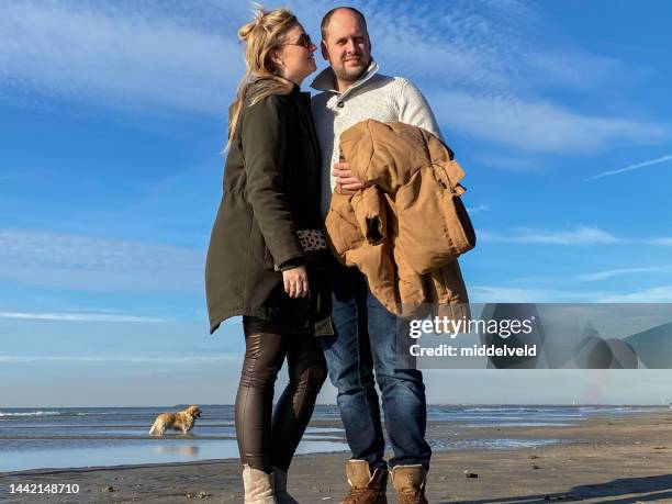 november beach walk - romantic couple walking winter beach stock pictures, royalty-free photos & images