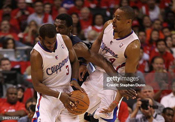 Chris Paul of the Los Angeles Clippers dribbles the ball into Tony Allen of the Memphis Grizzlies and teammate Randy Foye of the Clippers in the...