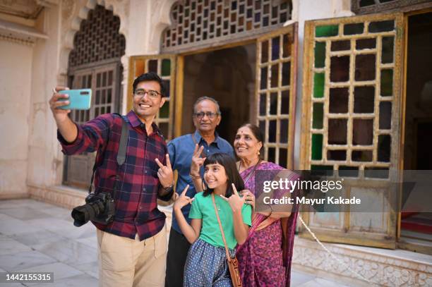 mid adult man clicking selfie with his family - father clicking selfie bildbanksfoton och bilder