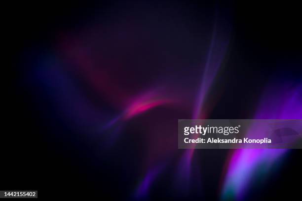 colorful neon rainbow aurora borealis or laser light leaks texture on black background - purple abstract stockfoto's en -beelden