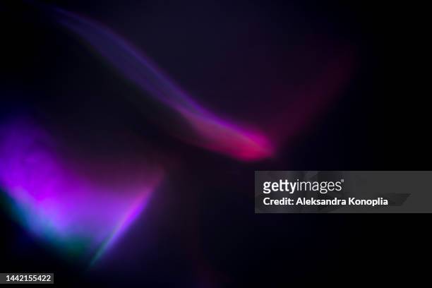 colorful neon rainbow aurora borealis or laser light leaks texture on black background - rainbow lens flare stock pictures, royalty-free photos & images
