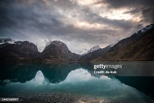 beautiful lake in the mountains at sunset. iskanderkul lake / tajikistan - mountain range night stock pictures, royalty-free photos & images