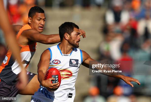 Israel Folau of the Giants competes for the ball against Karmichael Hunt of the Suns during the round seven AFL match between the Greater Western...